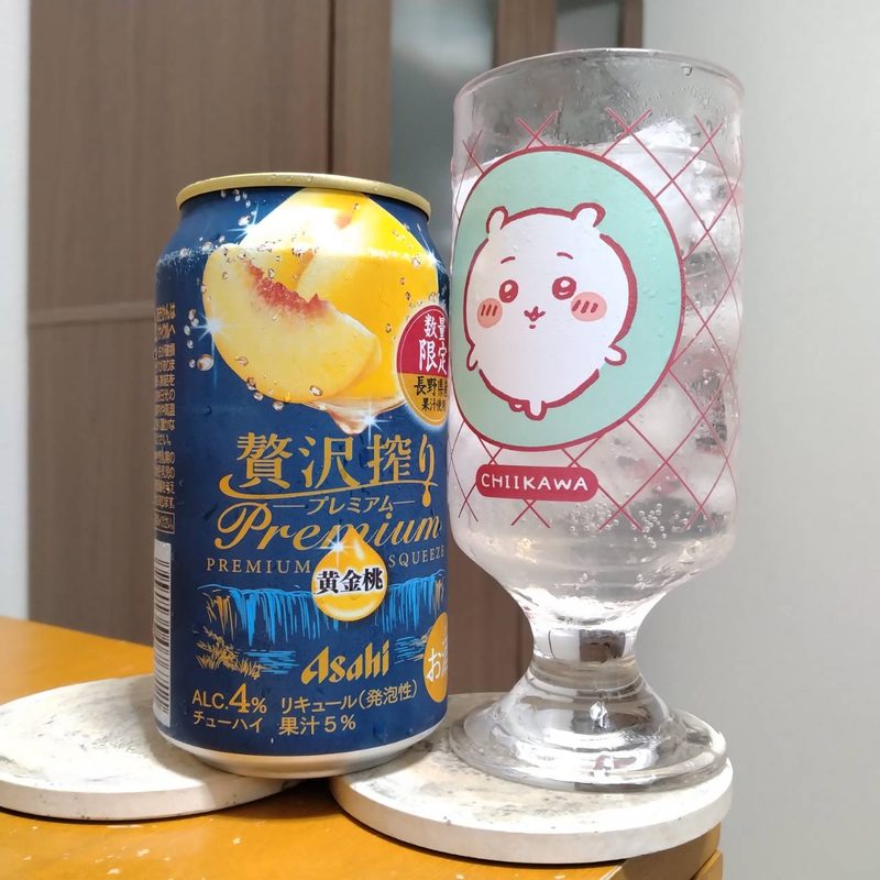 アサヒローソン限定贅沢搾りプレミアム長野県産黄金桃とグラスに注いだアサヒローソン限定贅沢搾りプレミアム長野県産黄金桃