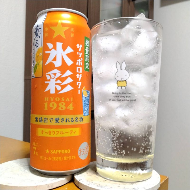 サッポロサワー氷彩1984薫るオレンジ仕立て(※生産終了品)とグラスに注いだサッポロサワー氷彩1984薫るオレンジ仕立て(※生産終了品)
